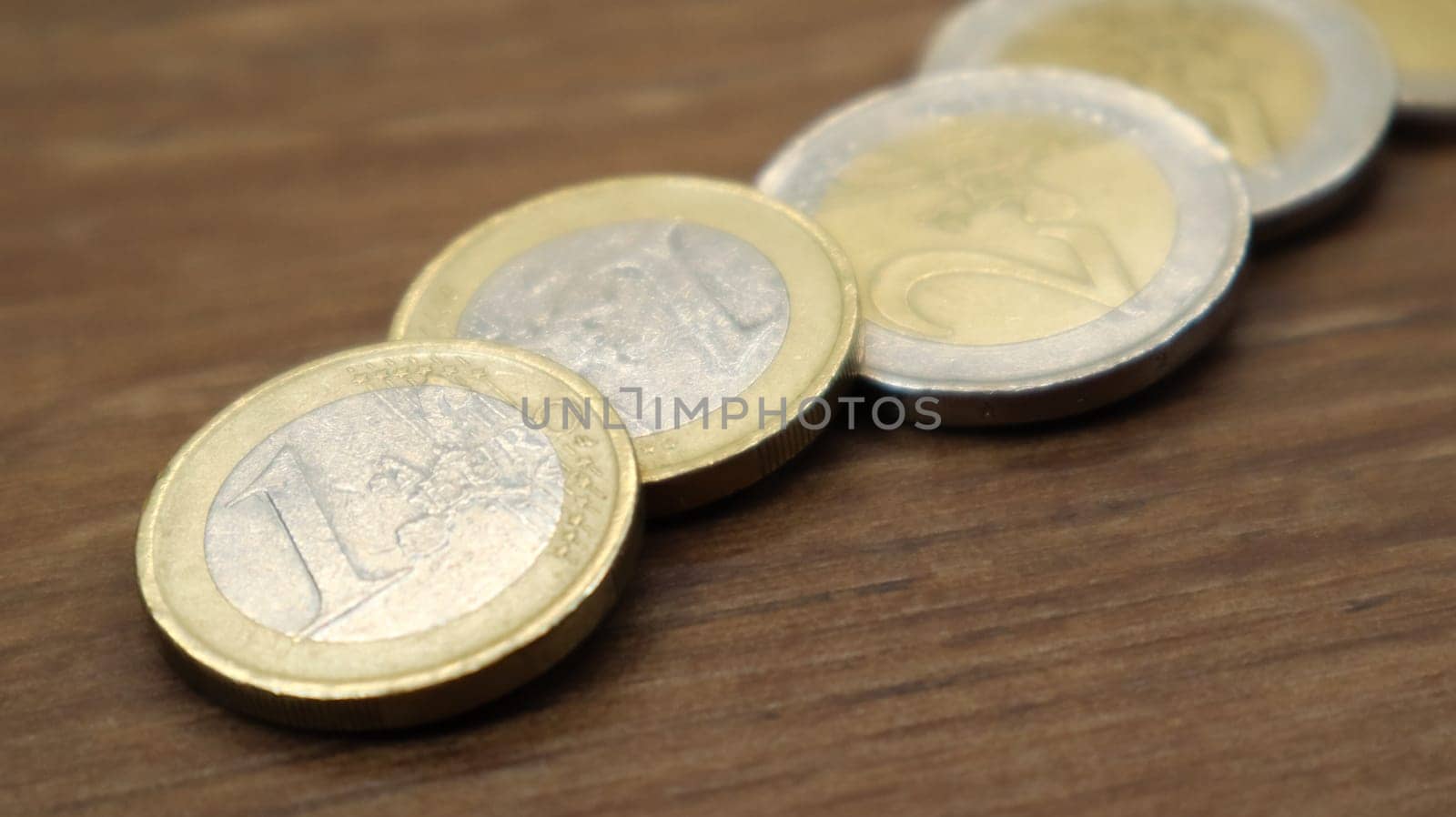 Shiny coins of one euro lie on the table. European Union currency