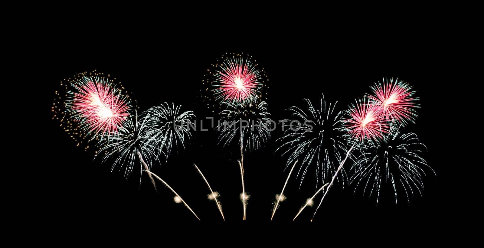 Red and green fireworks sparkling on night sky celebration