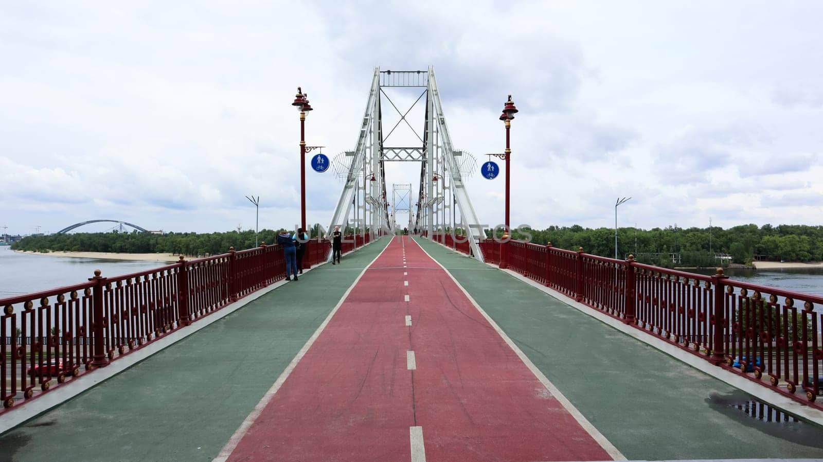 Ukraine, Kiev - June 2, 2020: Park pedestrian bridge over the Dnieper River, which connects the central part of Kiev with the park area and the beaches of Trukhanovy Island. Without people