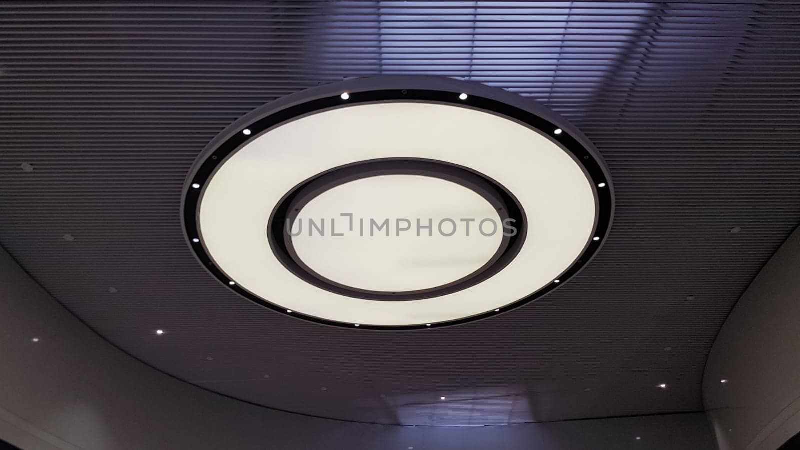 Round ceiling lamp on a suspended ceiling in a shopping center