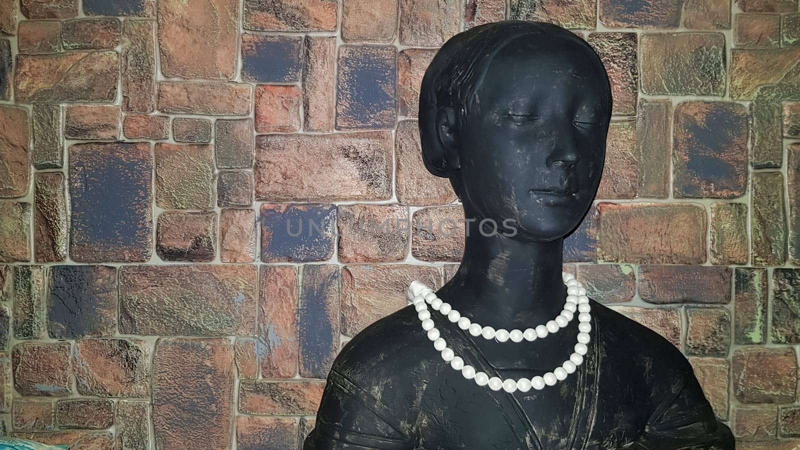 Ukraine, Kiev - June 10, 2020. Statuette of a woman's bust with white beads. Ceramic figurines and figurines decoration or symbol in the home interior
