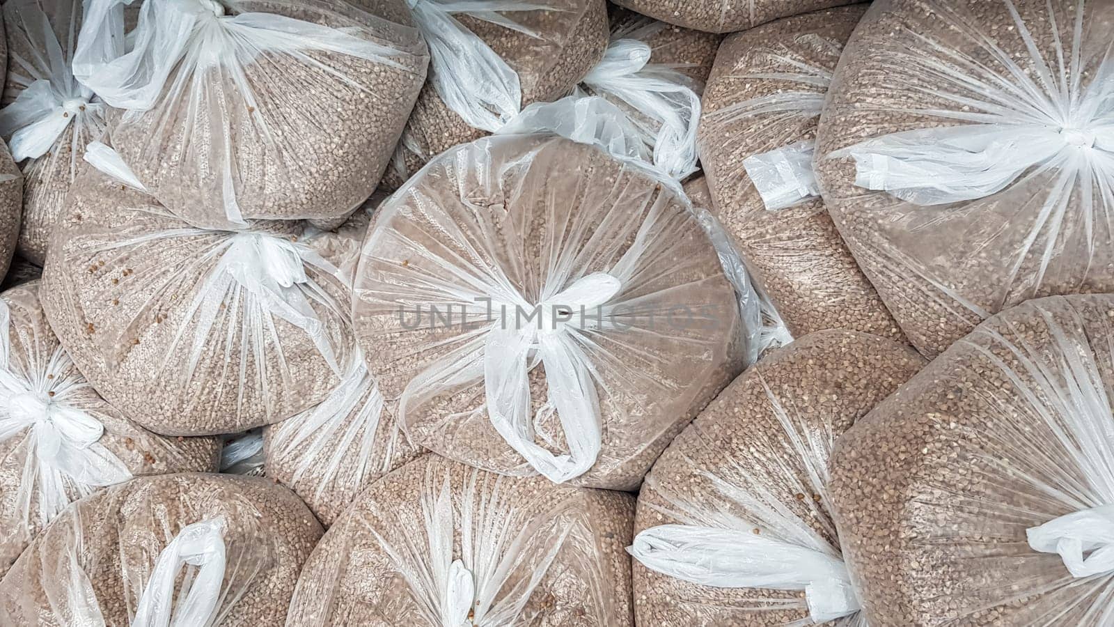 Shopping during a viral outbreak. Equipped weighed buckwheat in bags by employees of a grocery store or supermarket for safe shopping for store customers. pandemic. coronavirus