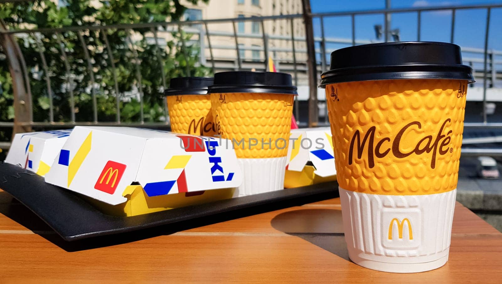 Ukraine, Kiev - August 29, 2020. Hamburger menu with coffee on a table on a tray in a McDonald's restaurant outdoors. Fast food and unhealthy food concept