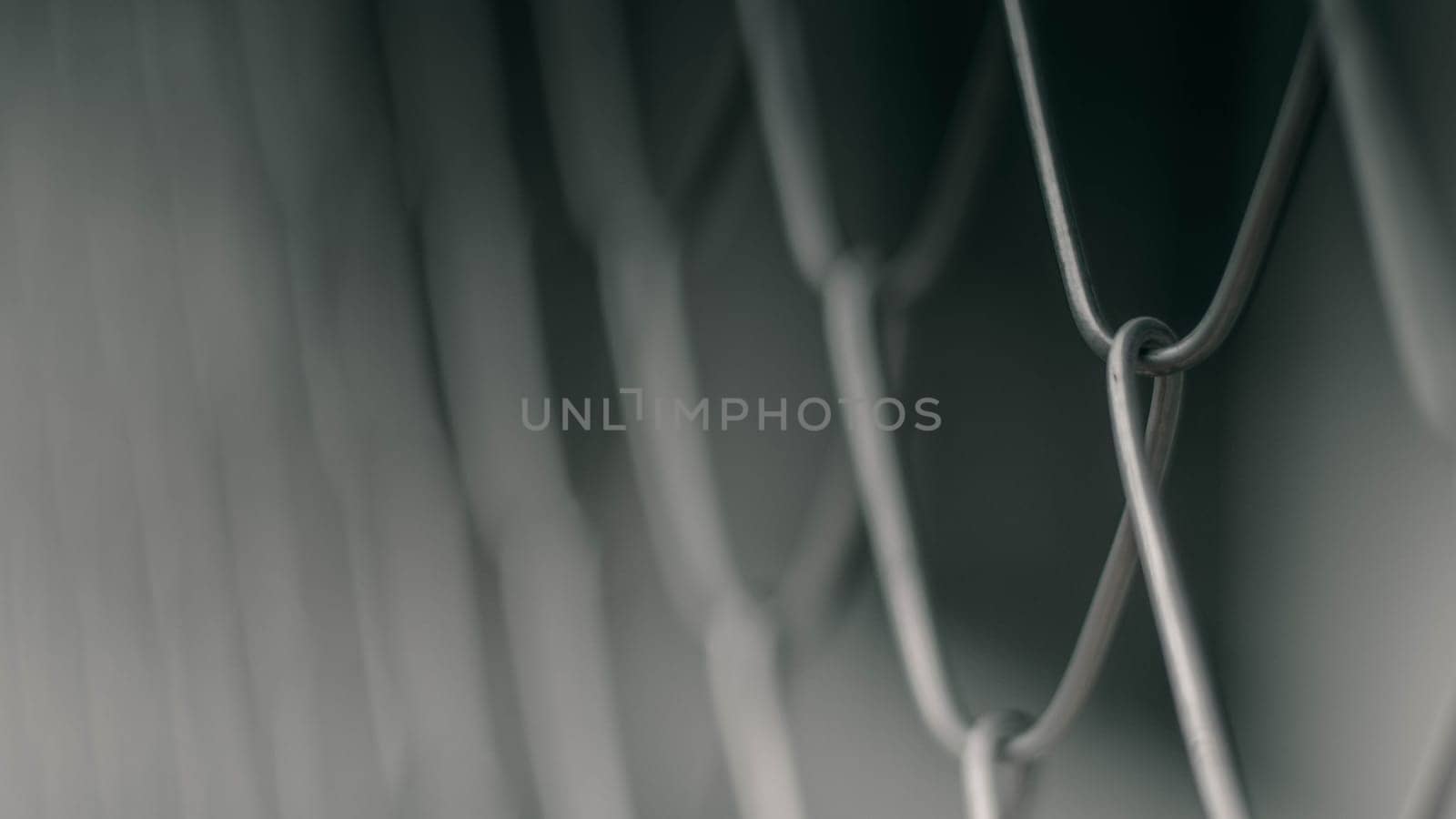 Close up Solid Metallic Wire Mesh Chain link Fence in Vintage Style Steel. Selective focus wire mesh fence