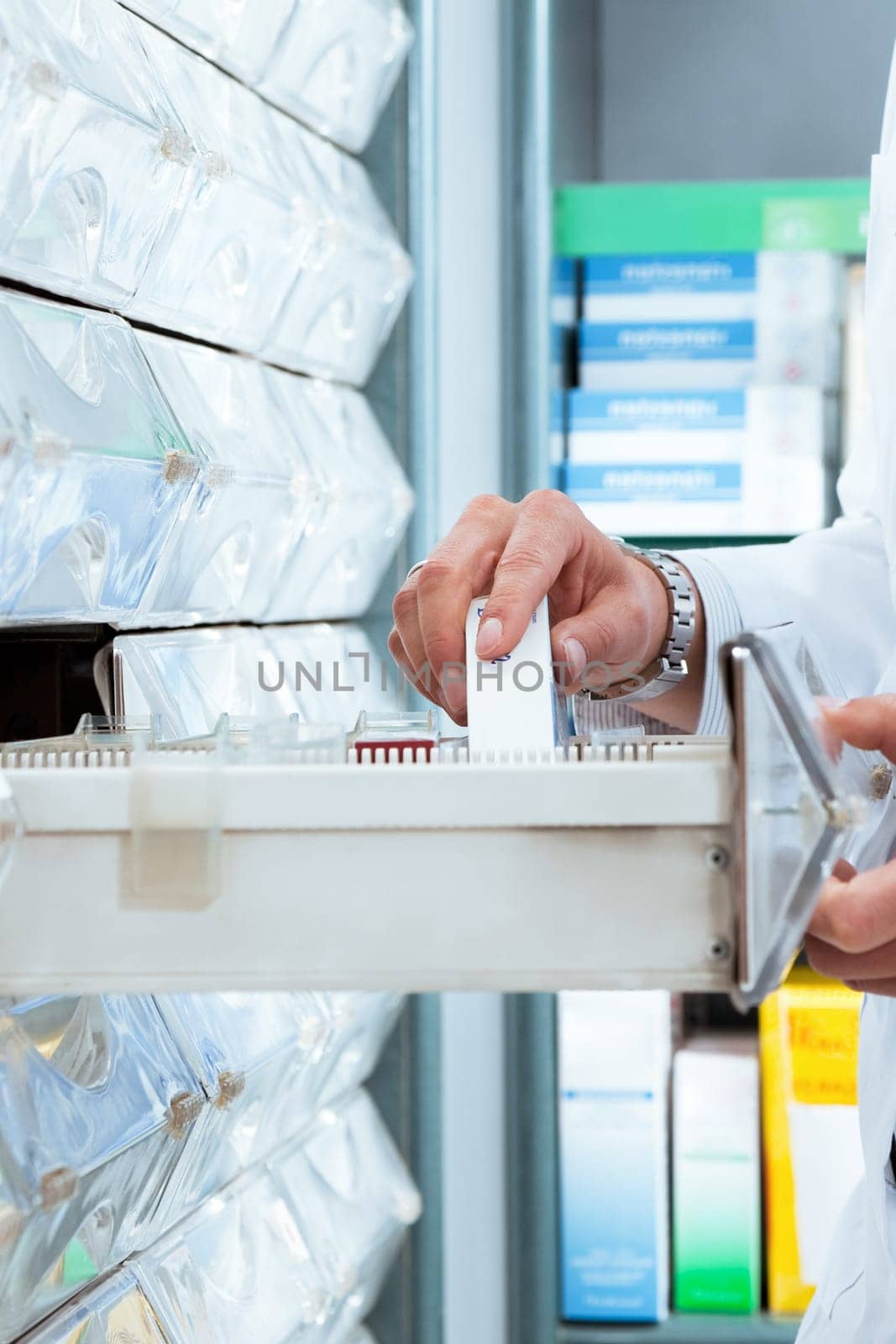 cropped view of pharmacist taking medicine from drawer. Copy space