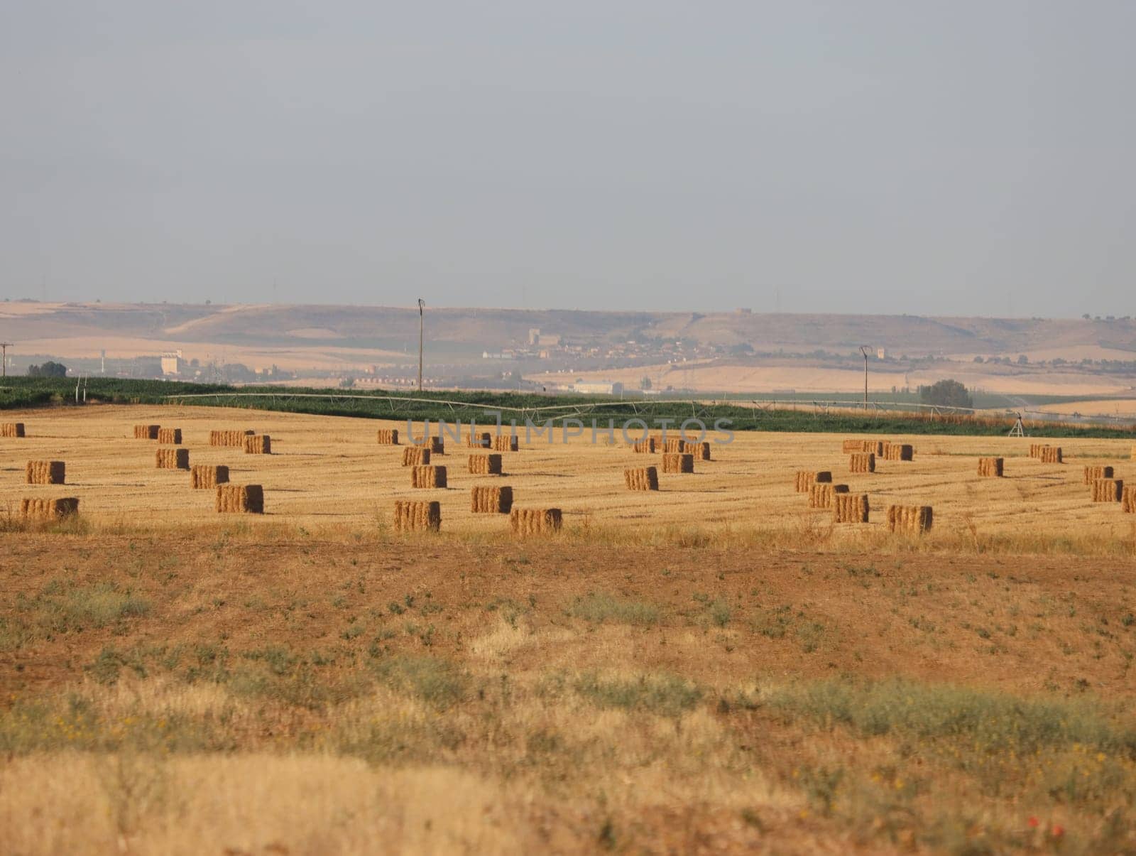 beautiful plateau field Spain harvests straw bales summer heat