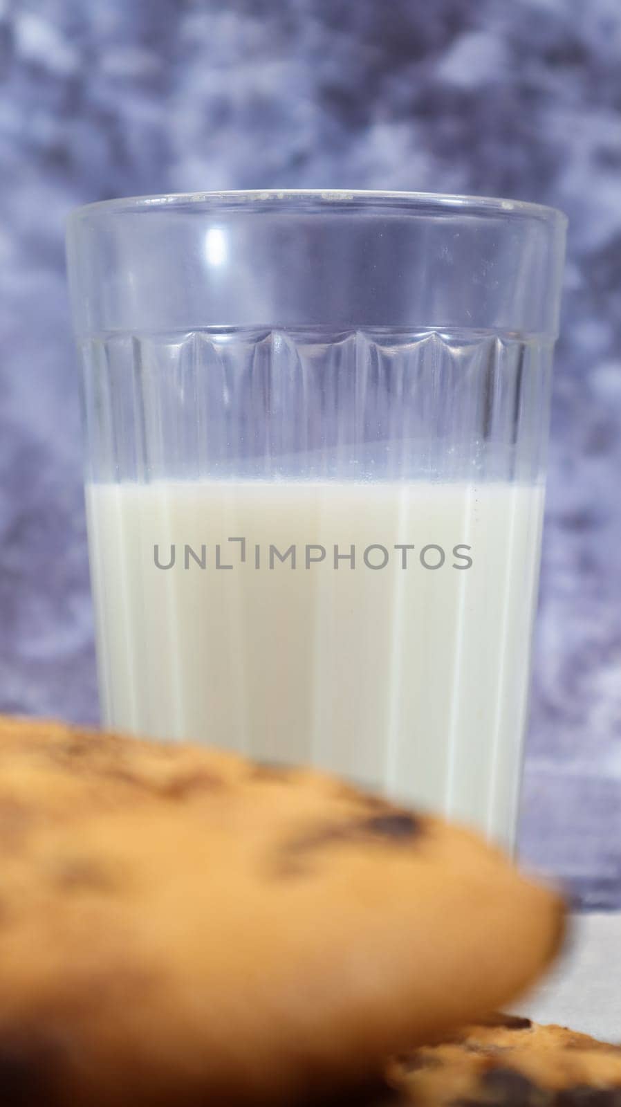 American gluten free chocolate chip cookies with glass glass of vegetable milk on gray background. Chocolate chip cookies. Sweet pastries, dessert. Culinary background. Vertical photography
