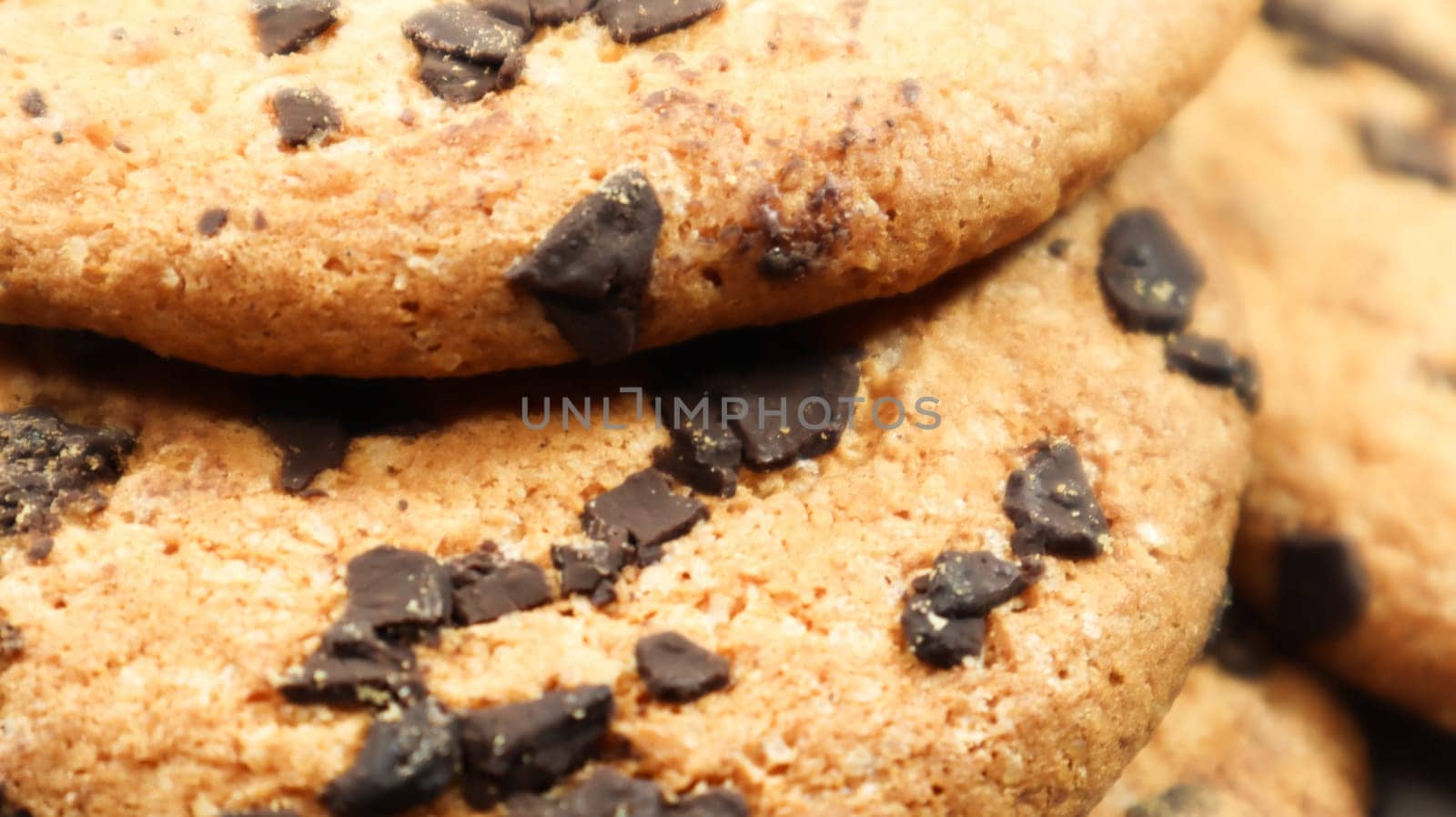 Soft, freshly baked chocolate chip cookies on a gray marble kitchen countertop. American traditional sweet pastry pastry, delicious homemade dessert. Culinary background. Close-up.