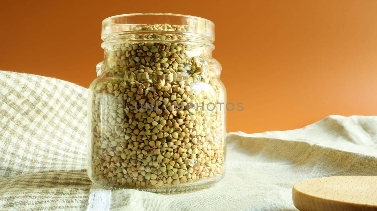 Green sprouts of raw organic buckwheat in a glass jar for cereals. Vegan food concept. Organic food. The concept of diet, weight loss, healthy and proper nutrition. Copy space for text