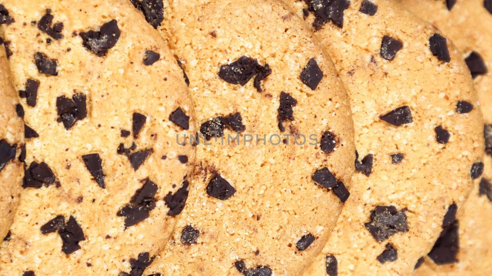 Soft, freshly baked chocolate chip cookies on a gray marble kitchen countertop. American traditional sweet pastry pastry, delicious homemade dessert. Culinary background. Close-up.