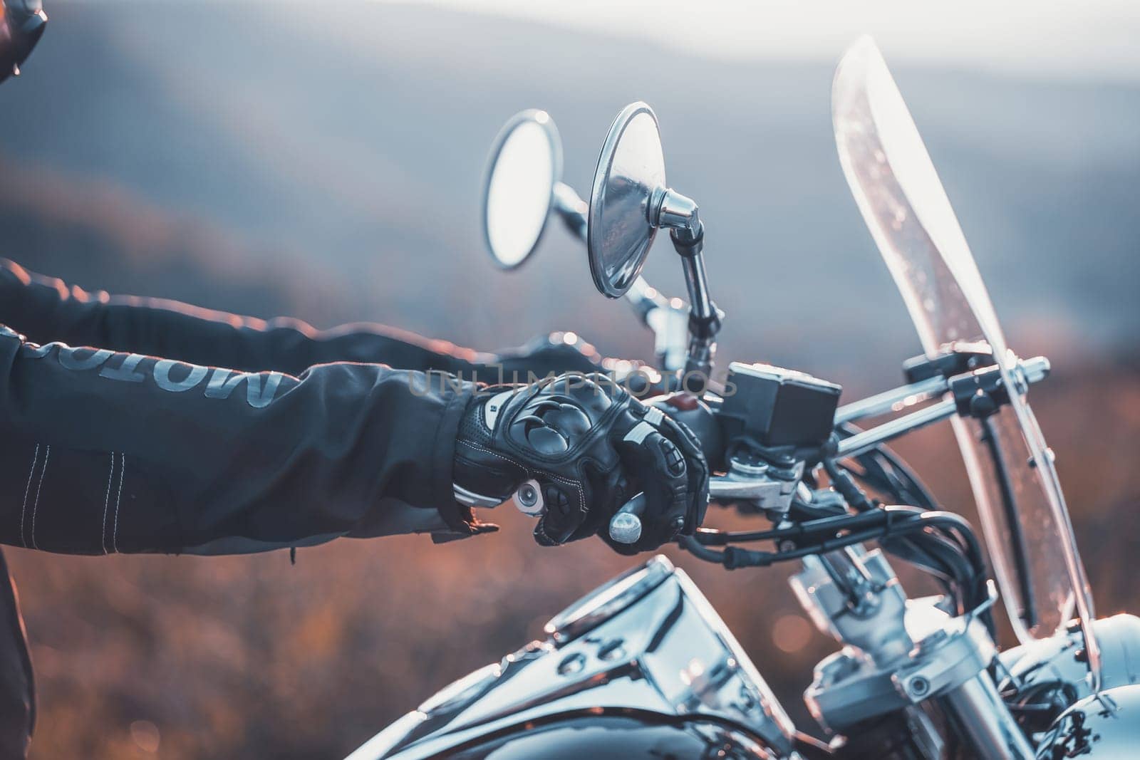Motorcycle driver riding on countryside. Travel and sport, speed and freedom concept