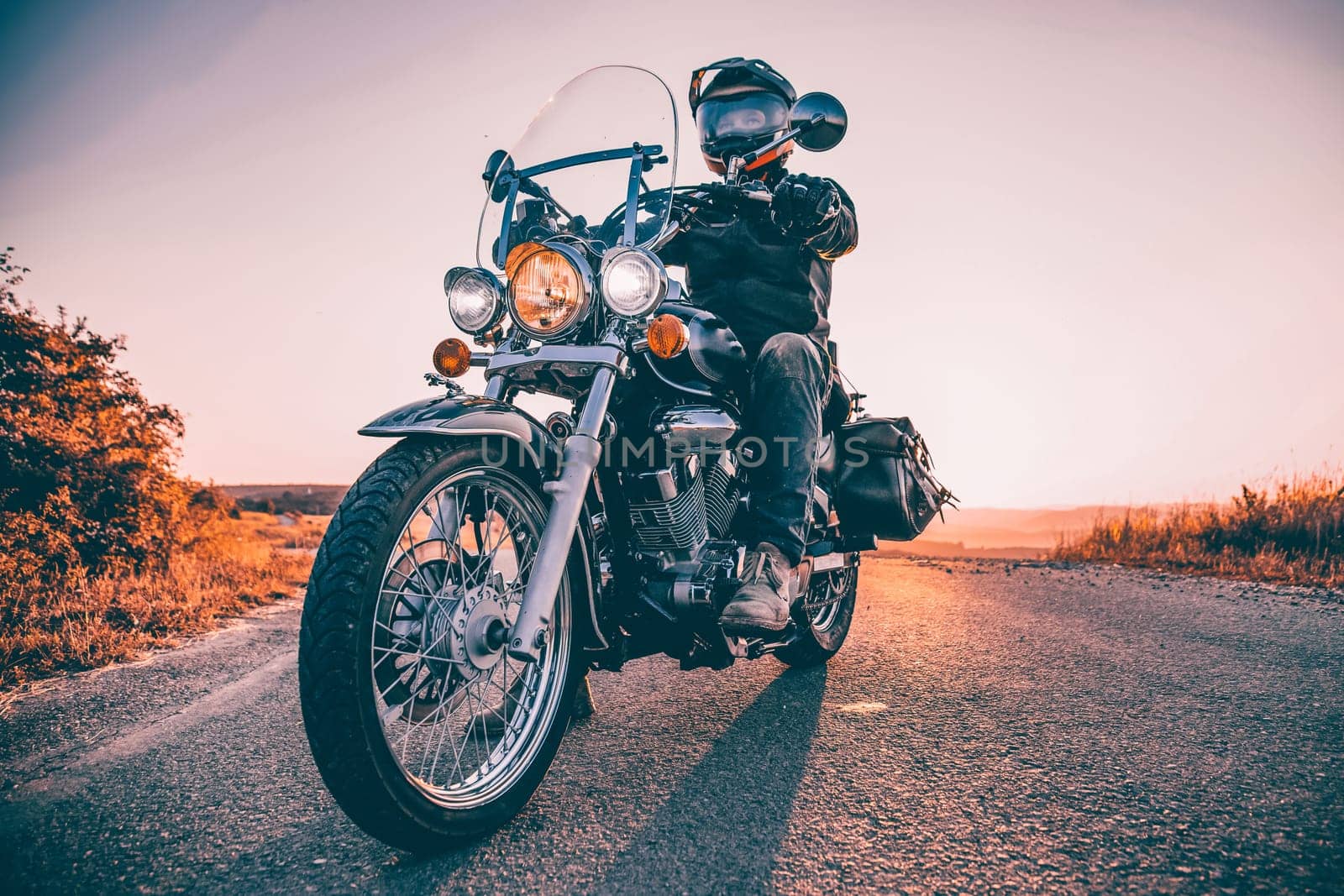 Motorcycle driver riding on countryside. Travel and sport, speed and freedom concept