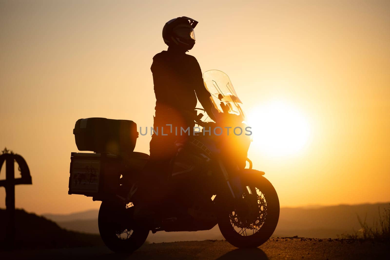 Motorcycle driver riding on countryside. Travel and sport, speed and freedom concept