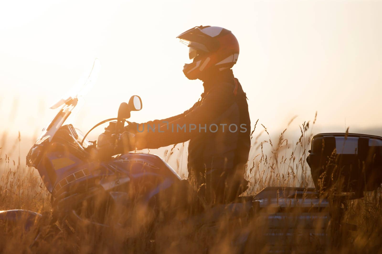 Motorcycle driver riding on countryside hills. Travel and sport, speed and freedom concept