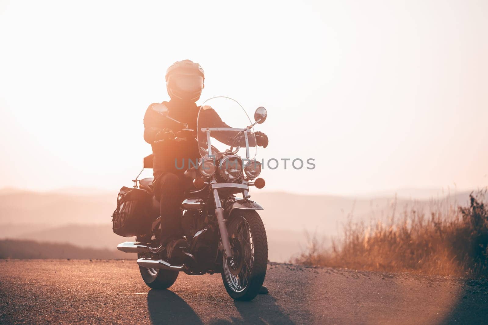 Motorcycle driver riding on countryside. Travel and sport, speed and freedom concept