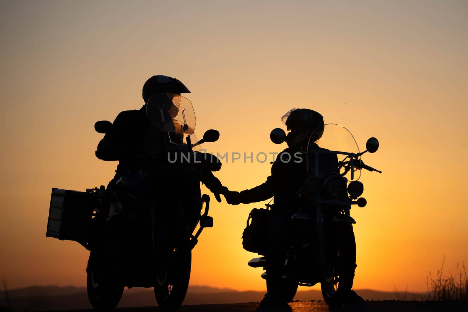 Motorcycle couple in sunset with classic motorcycle