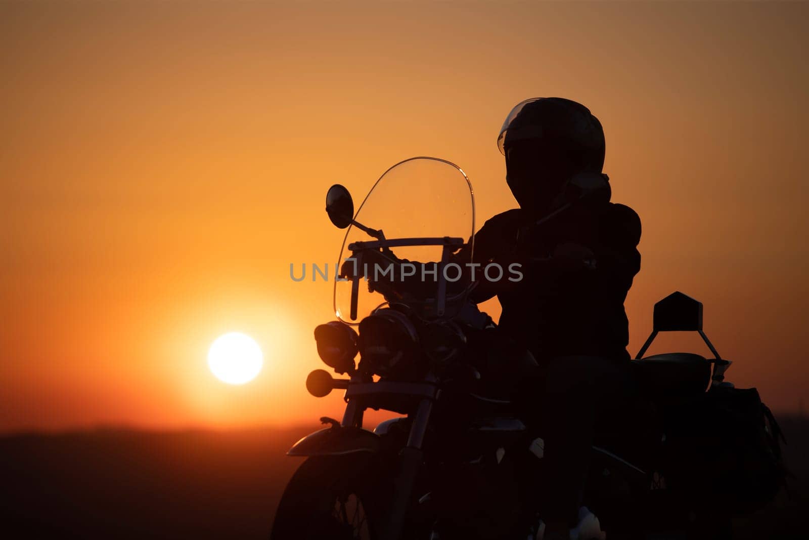 Motorcycle driver riding on countryside. Travel and sport, speed and freedom concept