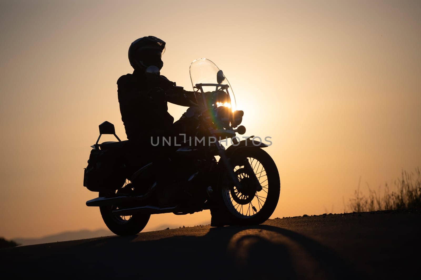 Motorcycle driver riding on countryside. Travel and sport, speed and freedom concept