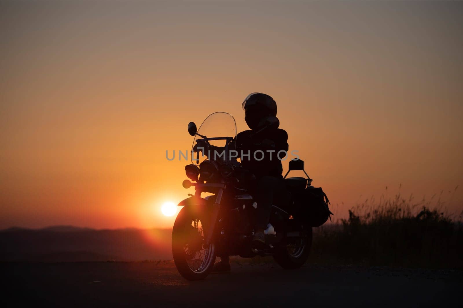 Motorcycle driver riding on countryside. Travel and sport, speed and freedom concept