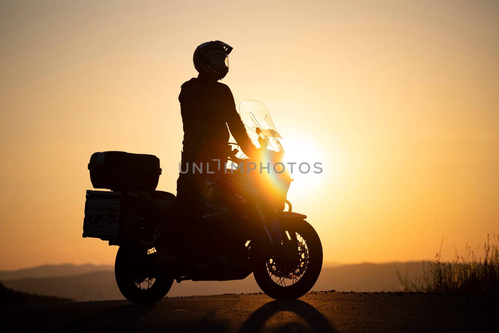 Motorcycle driver riding on countryside. Travel and sport, speed and freedom concept