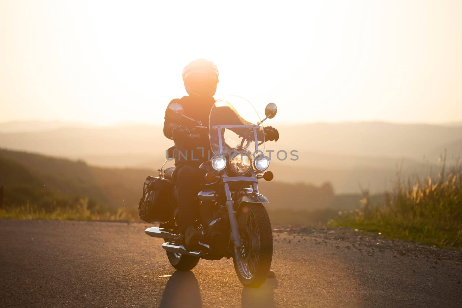 Motorcycle driver riding on countryside. Travel and sport, speed and freedom concept