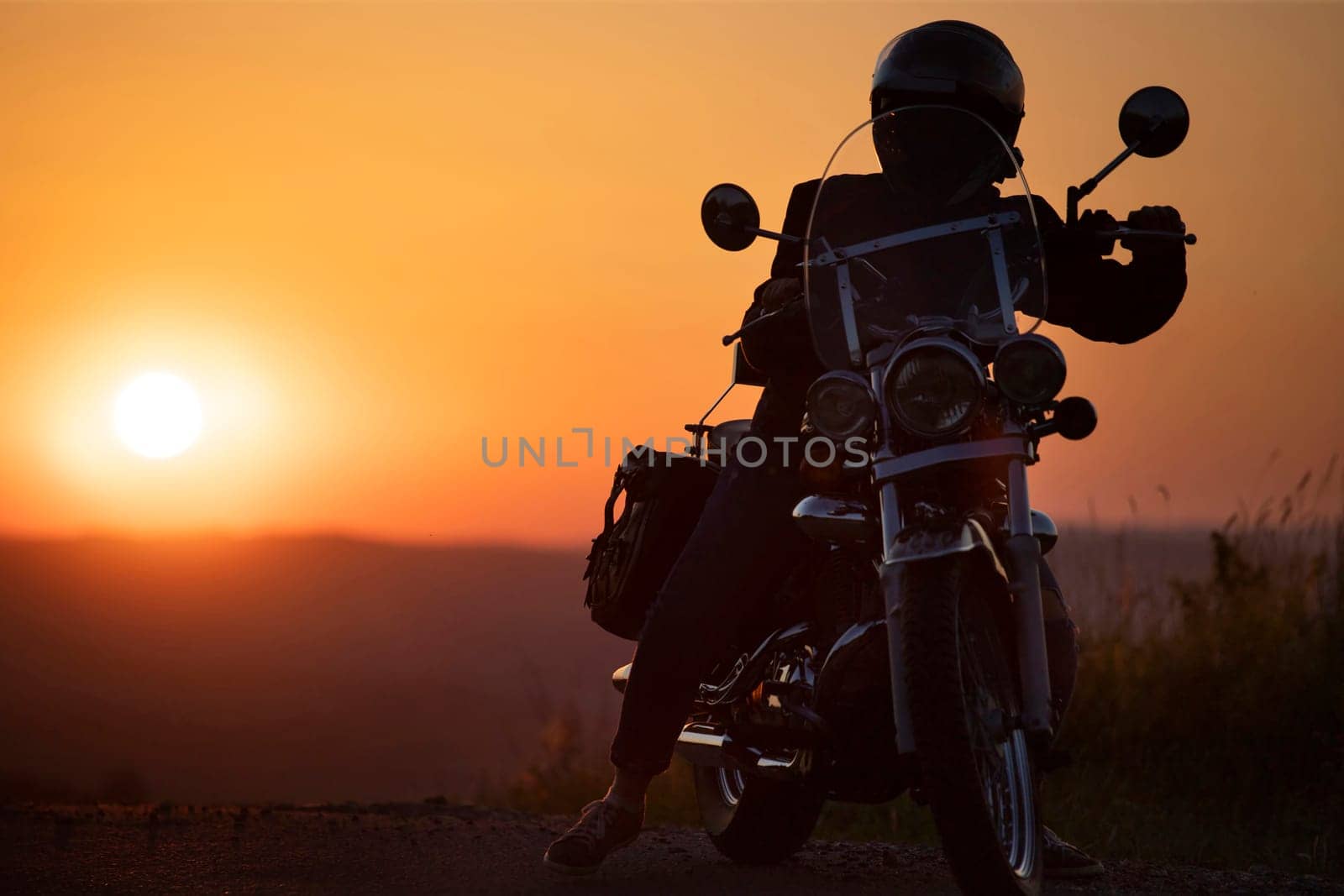 Motorcycle driver riding on countryside. Travel and sport, speed and freedom concept