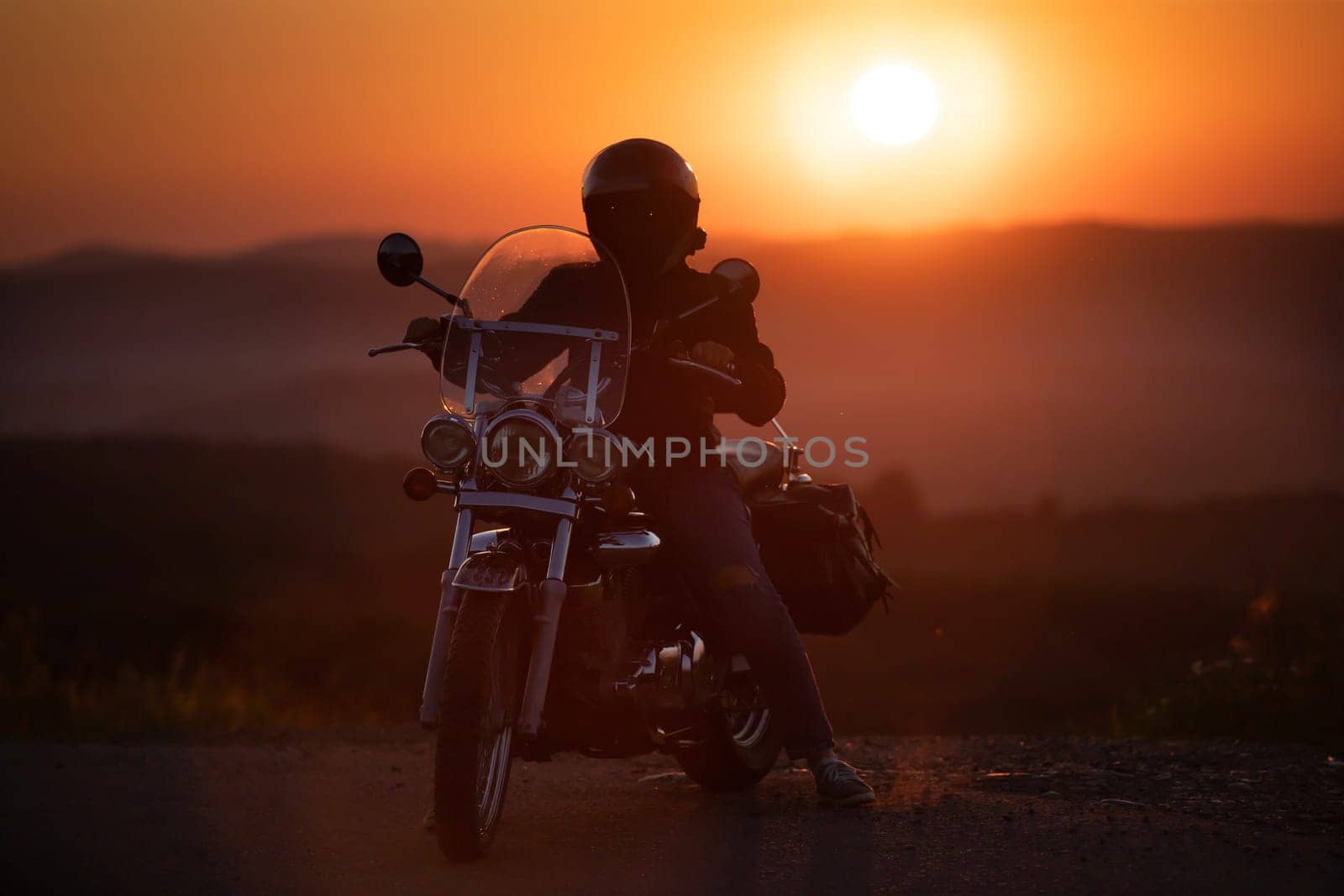 Motorcycle driver riding on countryside. Travel and sport, speed and freedom concept