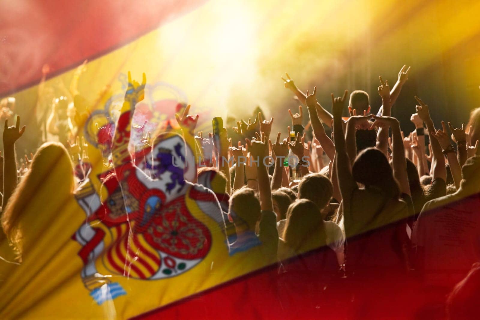 Football fans supporting Spain - crowd celebrating in stadium with raised hands against Spain flag