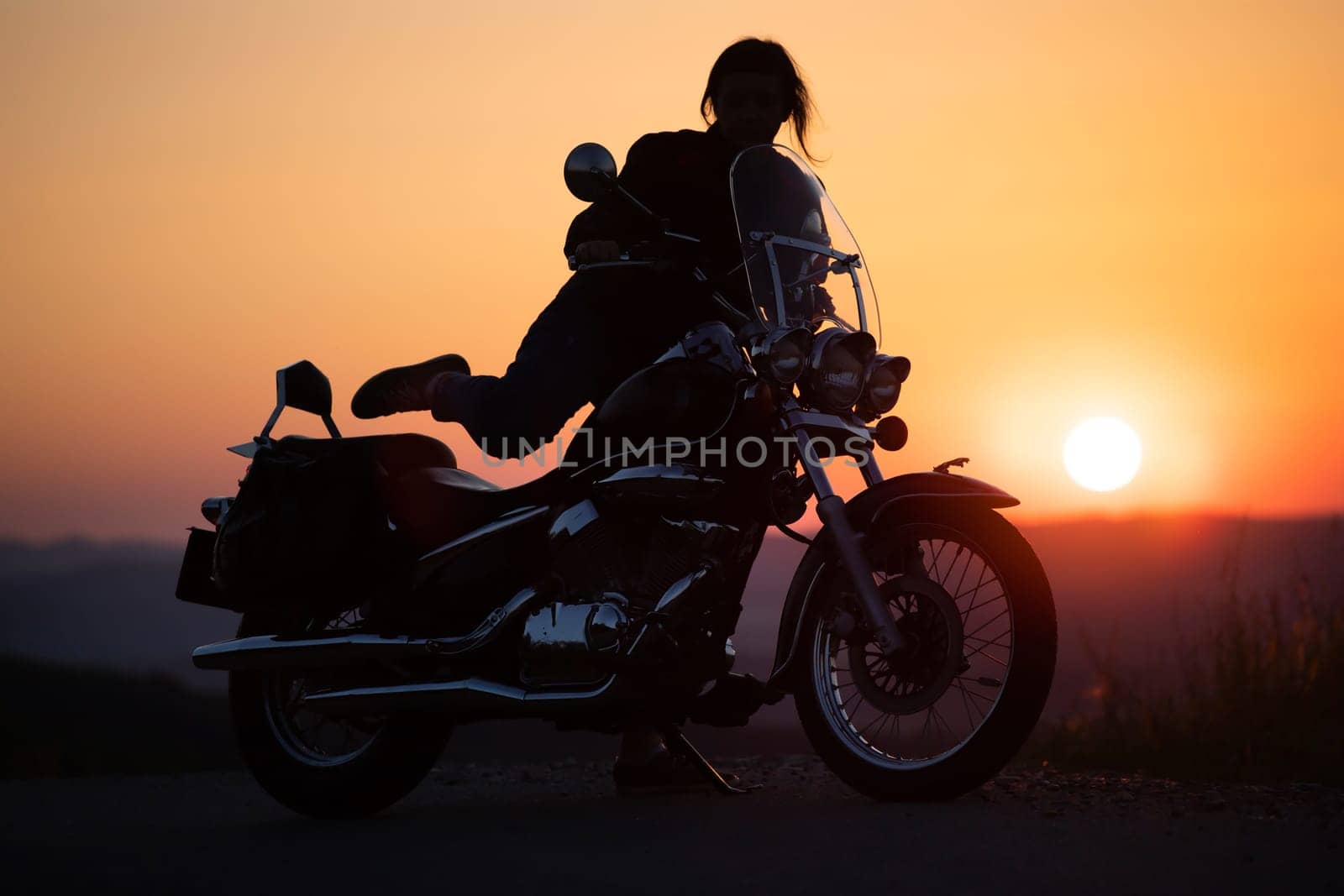 Motorcycle driver riding on countryside. Travel and sport, speed and freedom concept