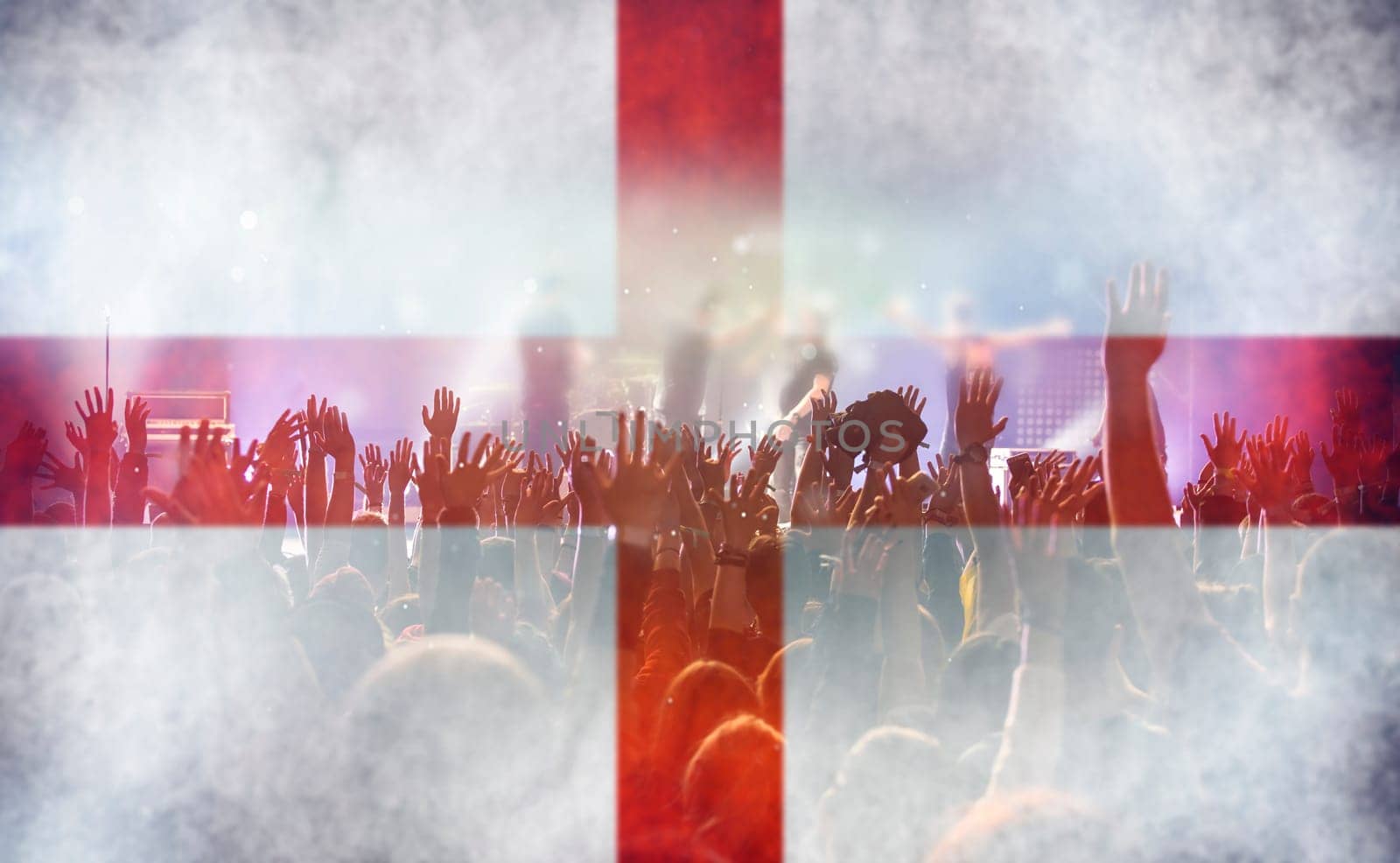 Football fans supporting England - crowd celebrating in stadium with raised hands against England flag