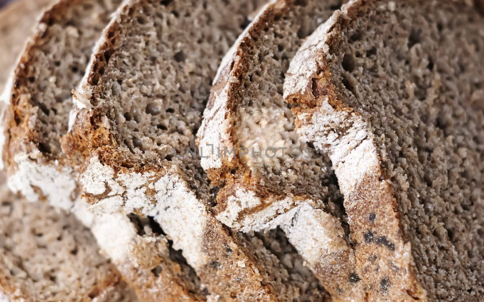 Close-up view of some slices of fresh rye bread. Healthy food and source of fiber. Bakery product
