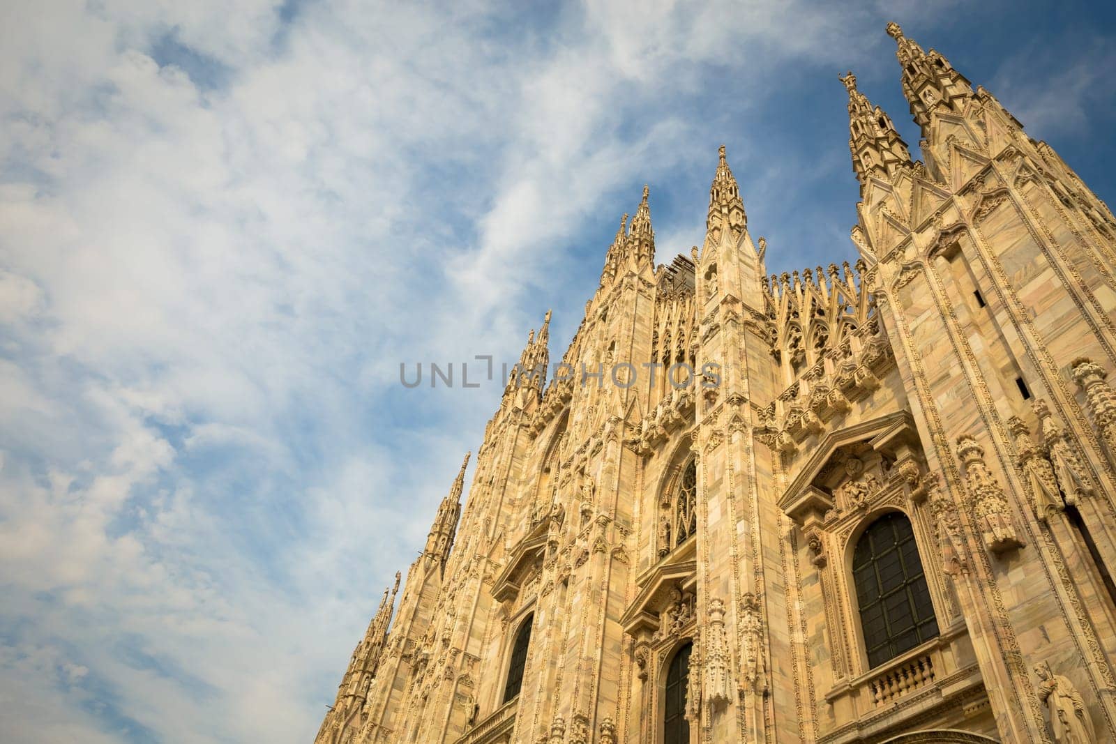 Milan Cathedral (Duomo di Milano) with copy space for text. Blue sky background and sunset light.
