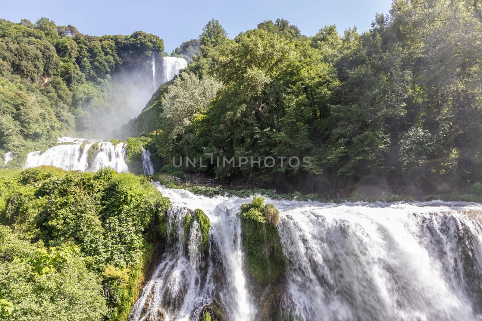 Marmore waterfall in Umbria region, Italy. Amazing cascade splashing into nature with trees and rocks.