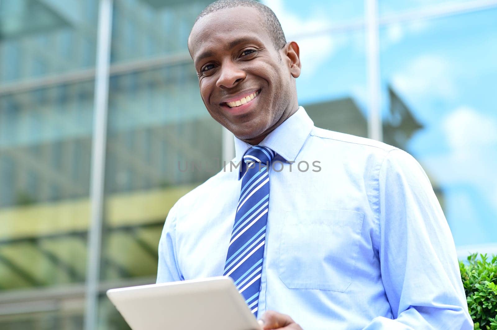 Happy business professional using a digital tablet