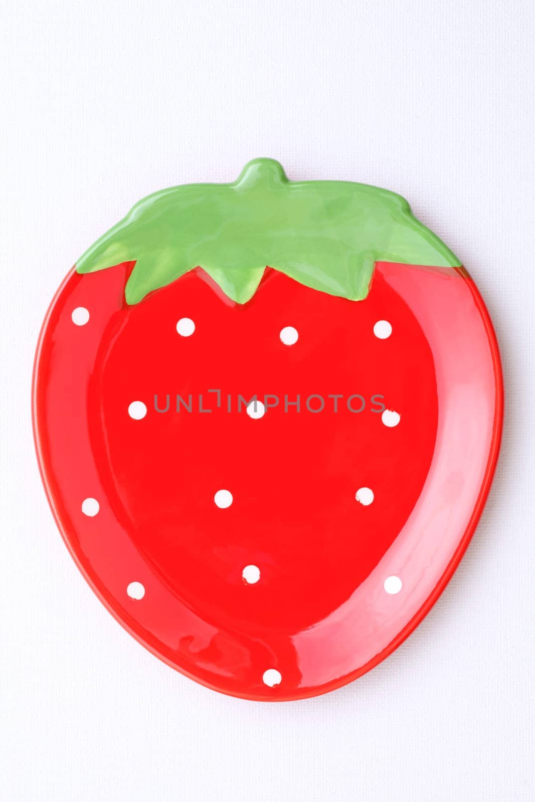 strawberry-shape plate on white background
