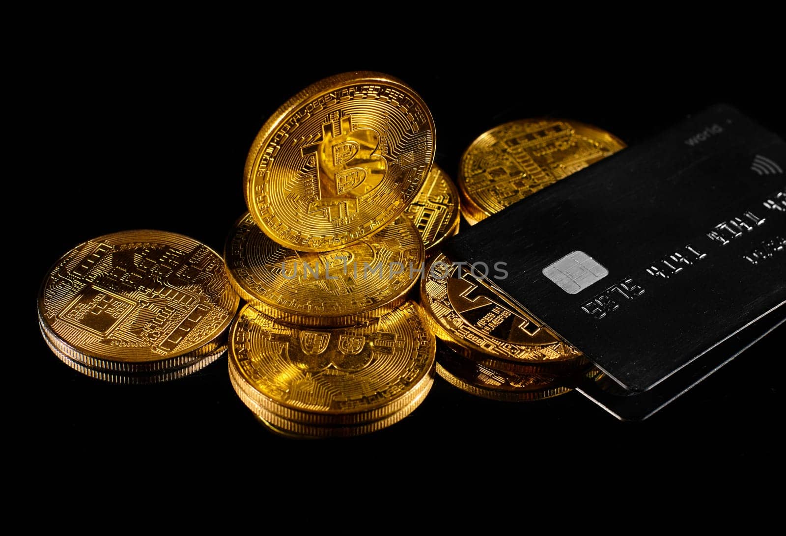 Leader in cryptocurrency BTC and bitcoin rewards card against black surface. Golden coin with bitcoin logo and credit card . Decentralized digital currency. Crypto payment. Electronic money or e-cash