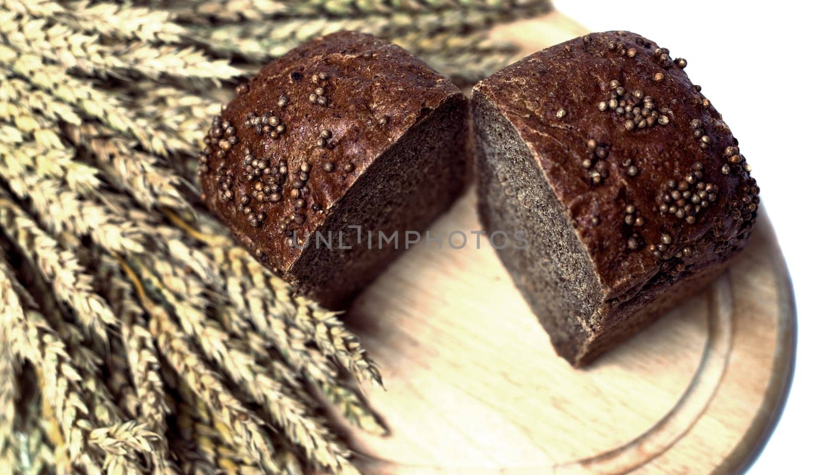 fresh bread and ears of wheat, isolated against white background