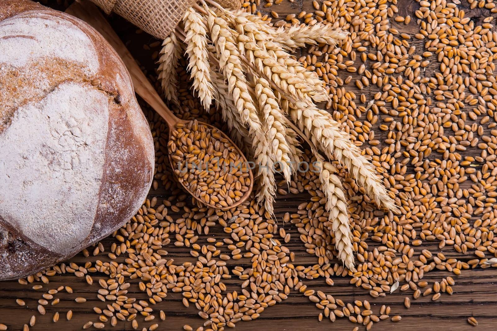 Assortment of baked bread on wooden table background
