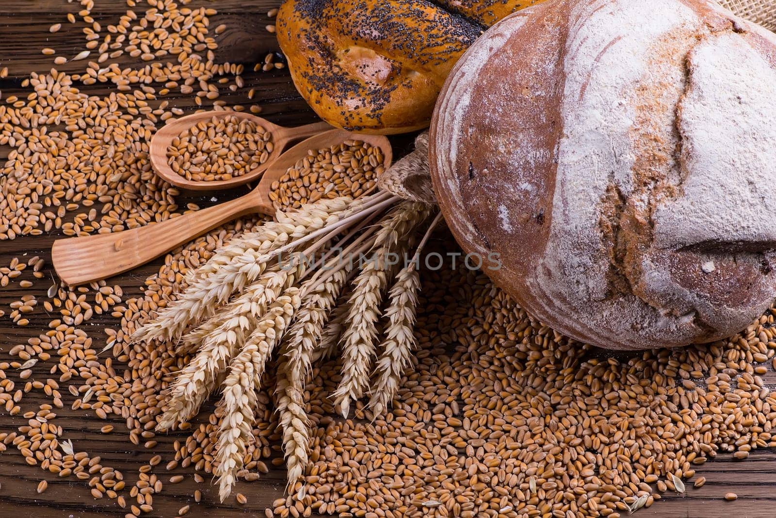 Assortment of baked bread on wooden table background