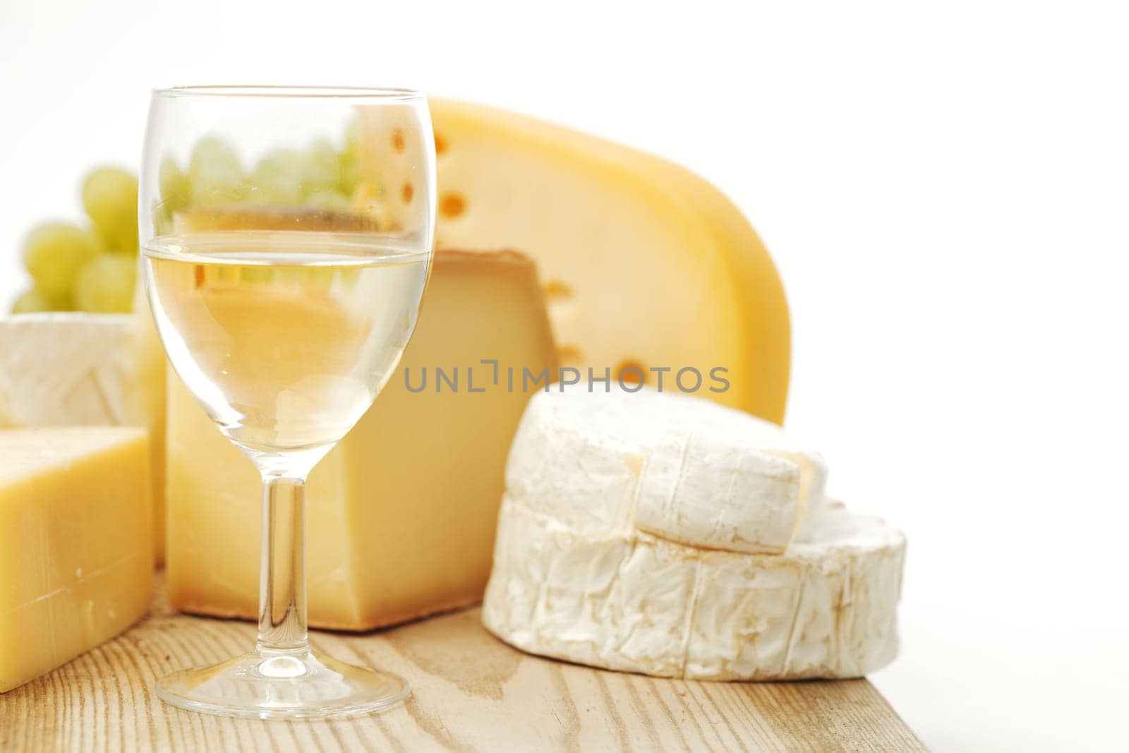 cheese and wine on a wooden table