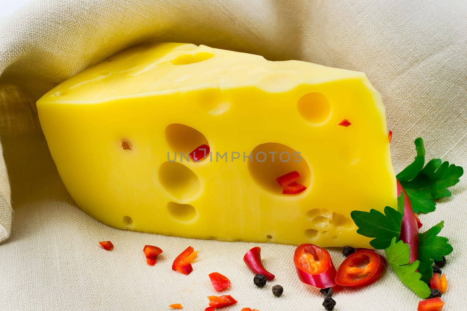 a piece of cheese with spices on canvas