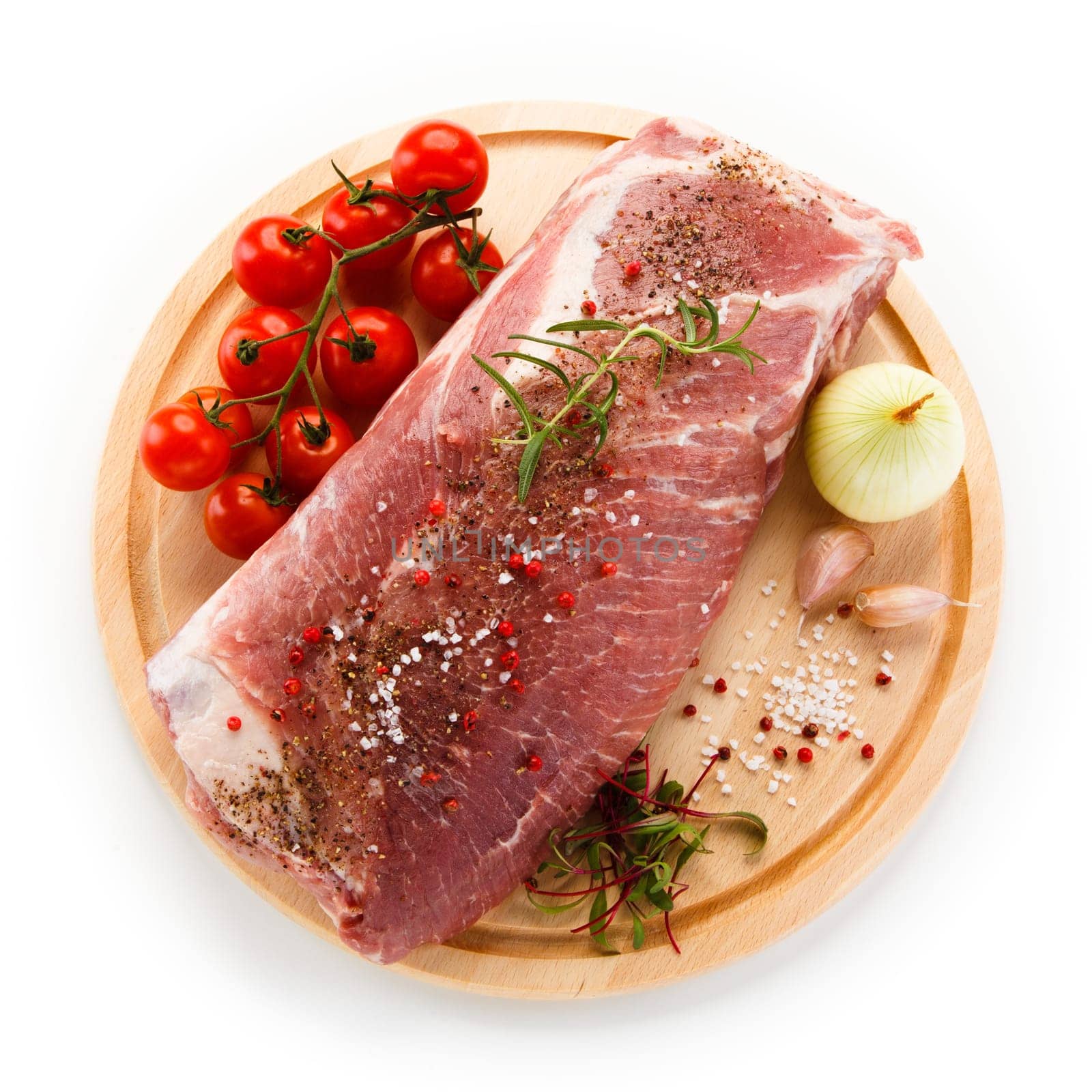 Raw pork chops on cutting board and vegetable
