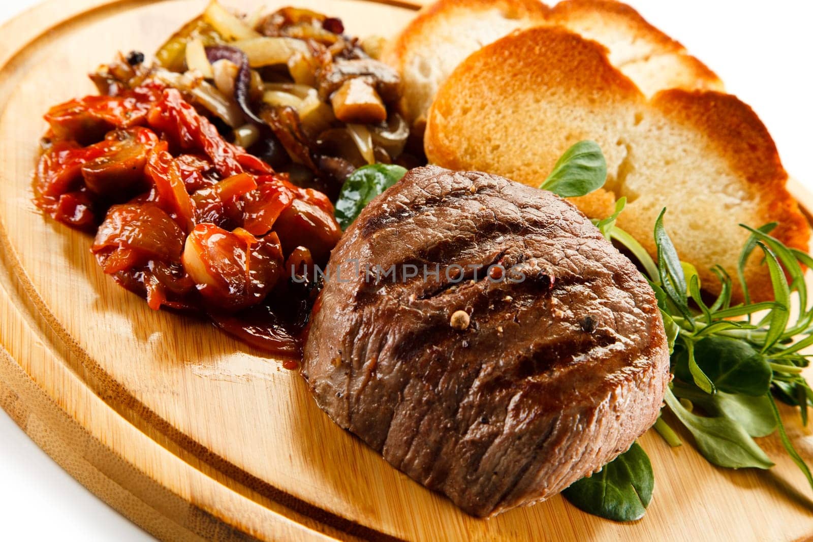 Grilled steak with toasted buns and vegetables