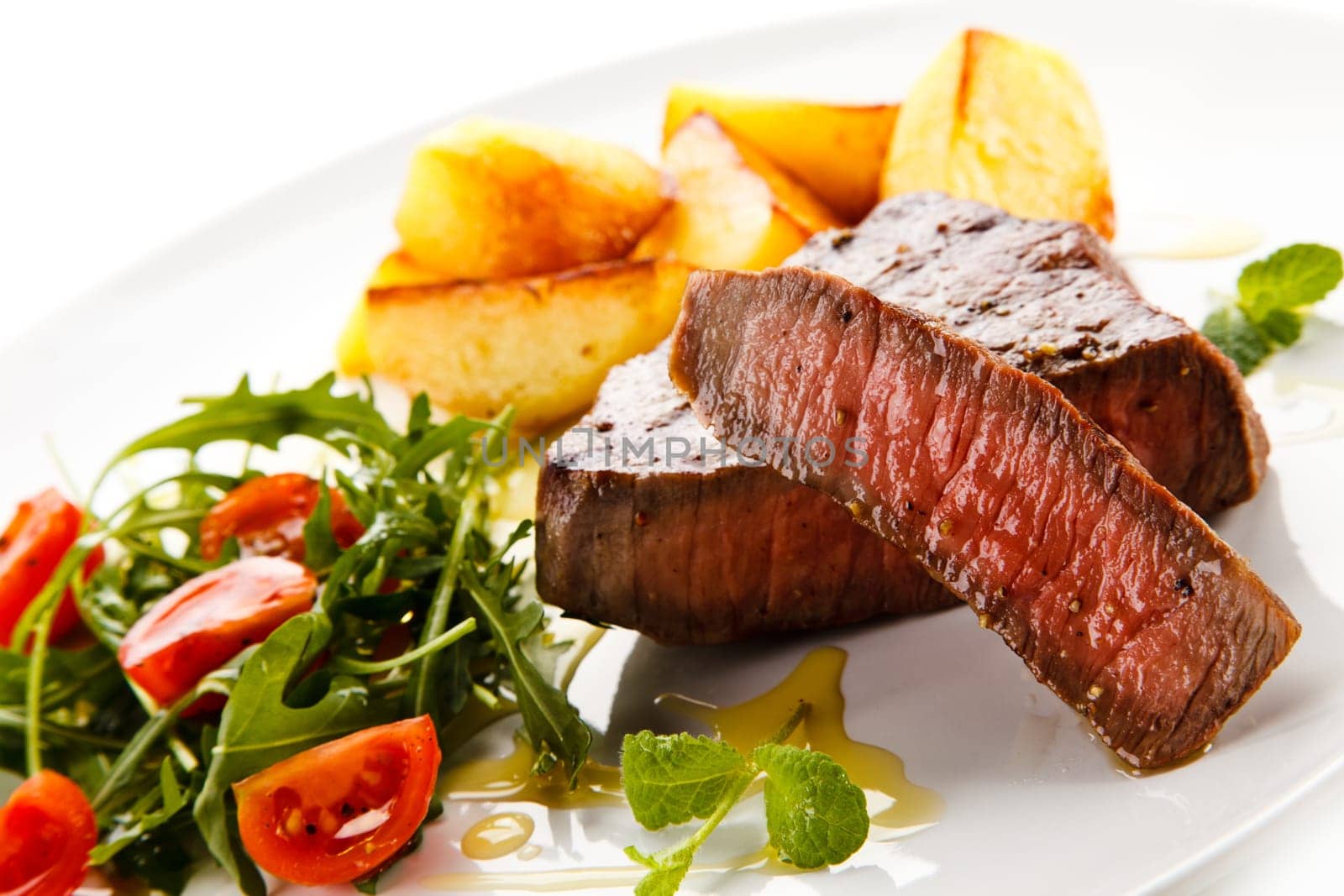 Grilled steaks, baked potatoes and vegetables