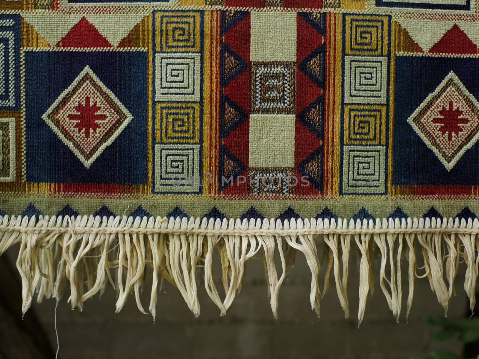 colored rug with fringe dries after washing close-up