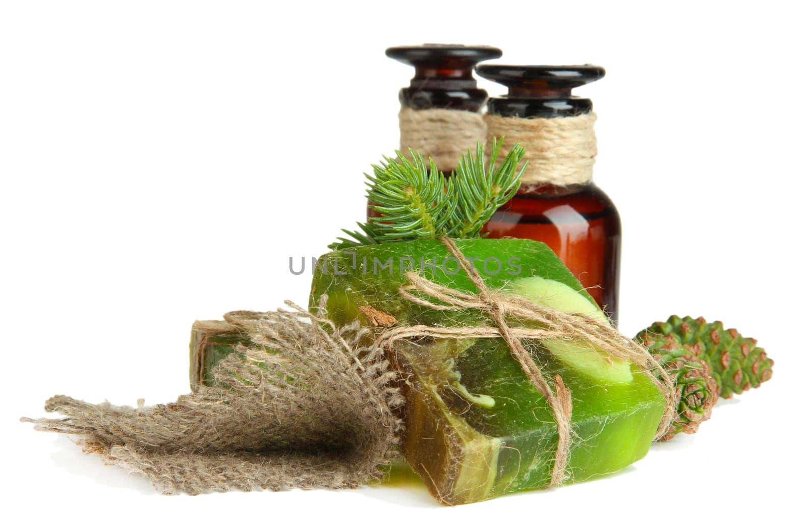 Hand-made soap and bottles of fir tree oil, isolated on white
