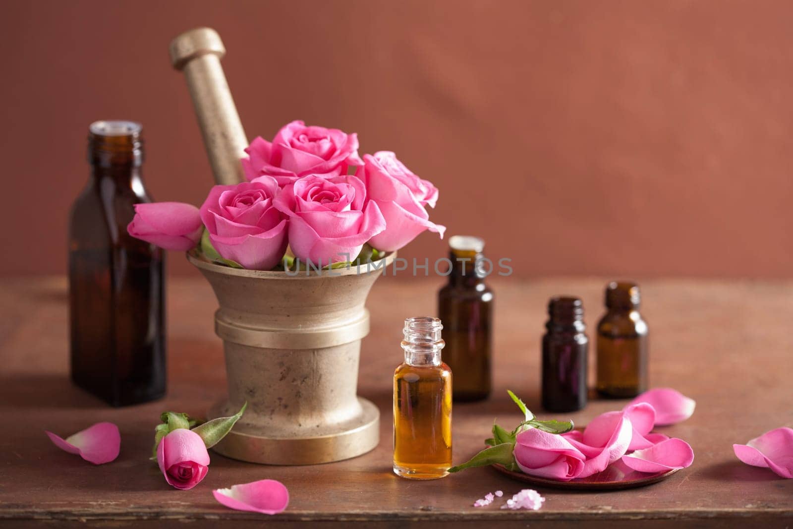 spa and aromatherapy set with rose flowers mortar essential oils