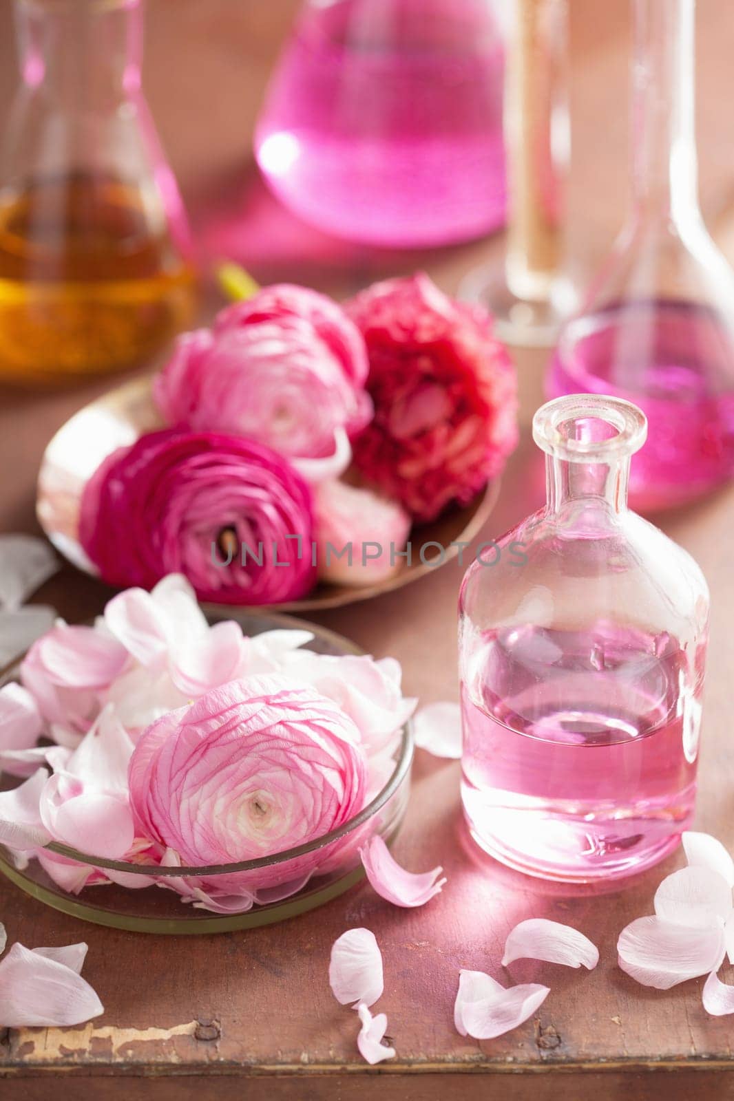 alchemy and aromatherapy set with ranunculus flowers and flasks
