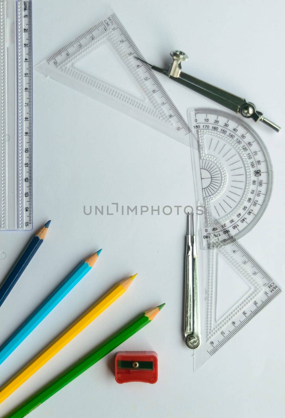 Geometric Measuring tools, Drawing items and mathematical instruments placed on white paper sheet. Back to school and Engineering education learning background. Empty Copy space room for text.