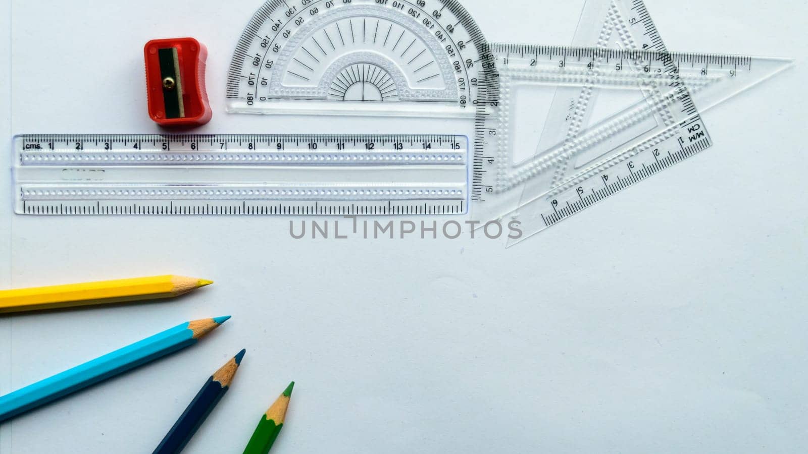 Geometric Measuring tools, Drawing items and mathematical instruments placed on white paper sheet. Back to school and Engineering education learning background. Empty Copy space room for text.